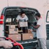 two men carrying boxes